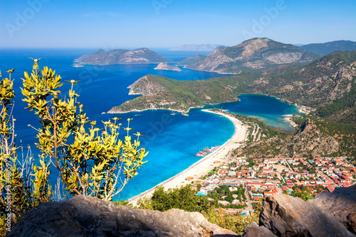Obraz na płótnie Summer scenery of blue lagoon with white sand located in the city Oludeniz. Beautiful view on summer sea and the town from top moutain. w salonie