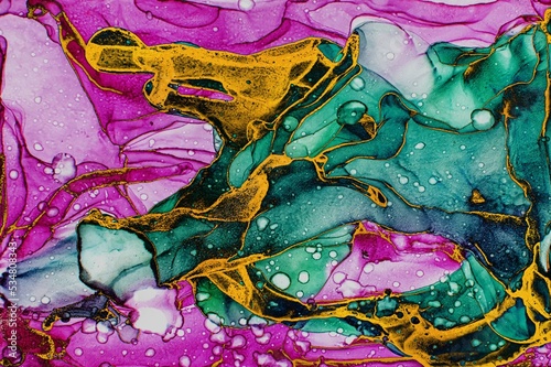 Golden dust on dark green and pink Alcohol ink fluid abstract texture fluid art with gold glitter and liquid.
