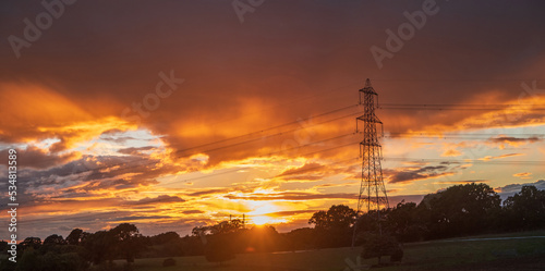 Power line silhouette on colorful sunset background