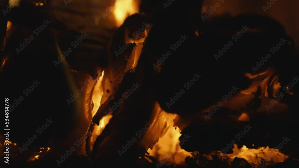 Fireplace, flames over wooden logs. Cozy fire. Close up, Macro. Burning firewood. Depth of field. Filmed in RAW 120fps 4K Fireplace, flames over wooden logs. Cozy fire. Close up, Macro. Burning firewood. Depth of field. Filmed in RAW 120fps 4K