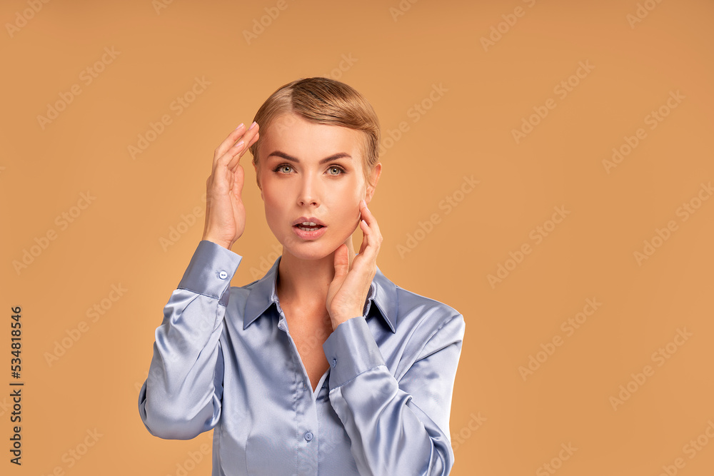 Beauty studio portrait of caucasian attractive woman with blonde short hair. Natural, delicate makeup. Fashionable haircut. Skin care, anti aging concept.