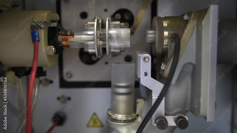 Details from an ICP-OES equipment where a radio frequency is used to heat a argon plasma and create atomic emission for chemical analysis purposes Details from an ICP-OES equipment where a radio frequency is used to heat a argon plasma and create atomic emission for chemical analysis purposes