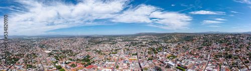 Aerial: panoramic cityscape and landscape in San Miguel de Allende. Drone view 