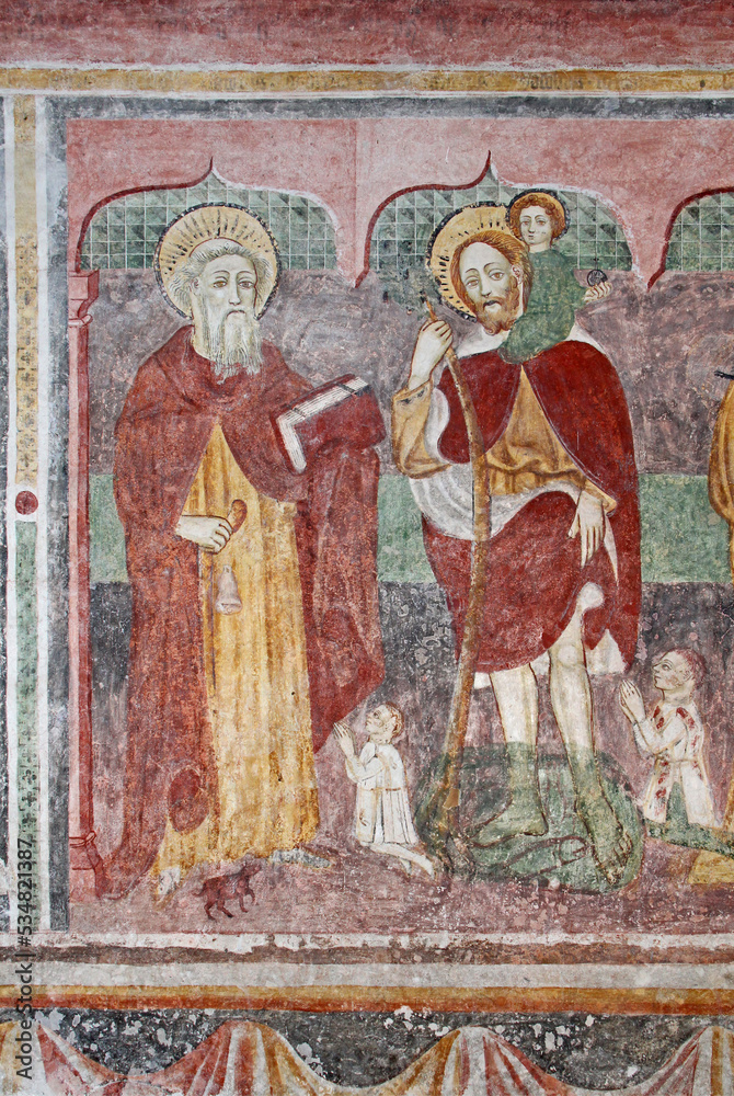 Sant'Antonio Abate e San Cristoforo.  Affresco nella chiesetta dei Santi Ippolito e Cassiano a Castel Tesino (Trentino)