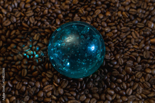 Blue glass bowl on coffee beans