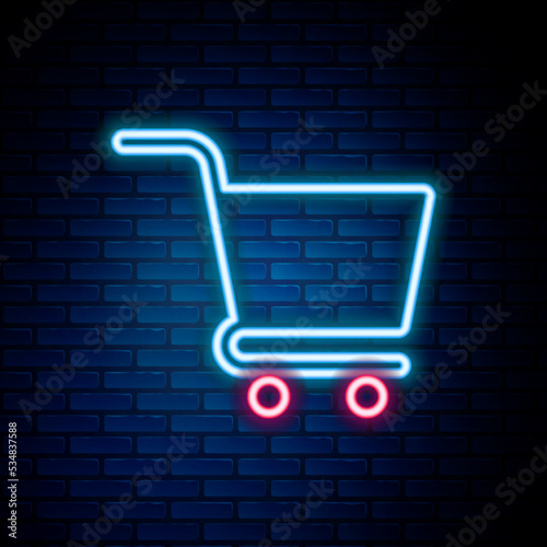 Glowing neon line Shopping cart icon isolated on brick wall background. Online buying concept. Delivery service sign. Supermarket basket symbol. Colorful outline concept. Vector