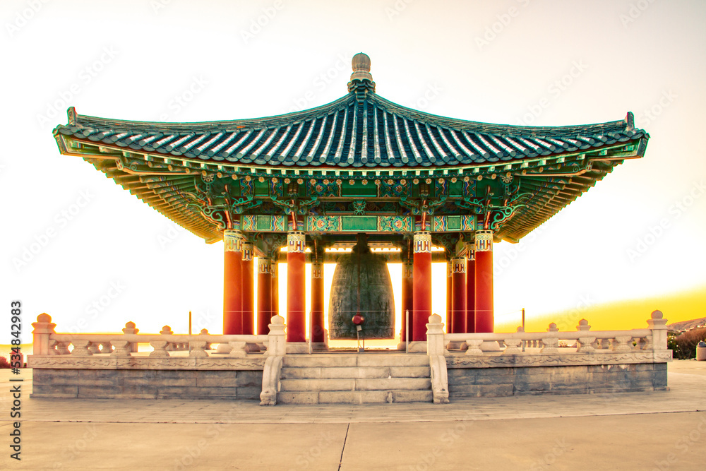 Fototapeta premium Panoramic traditional Korean design temple, gazebo, structure in the park at sunset 