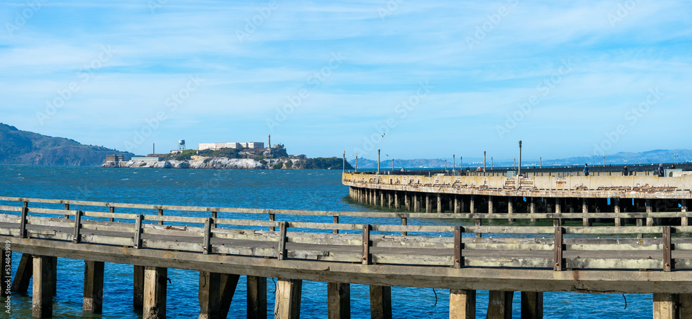 Fototapeta premium Pier on sea and the Alcatraz Island in the background 