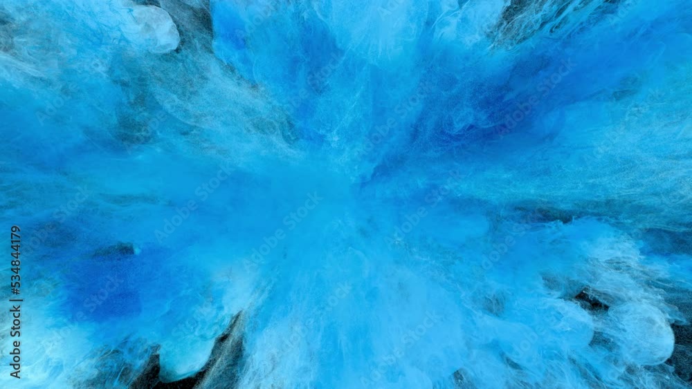 Color Burst - Colorful light blue smoke powder explosion close up. Coloured fluid ink particles in slow motion. Isolated on black background. Alpha matte 4k.