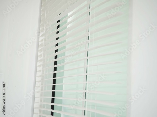 Blinds in a home catching the sunlight. Closeup photo, blurred.
