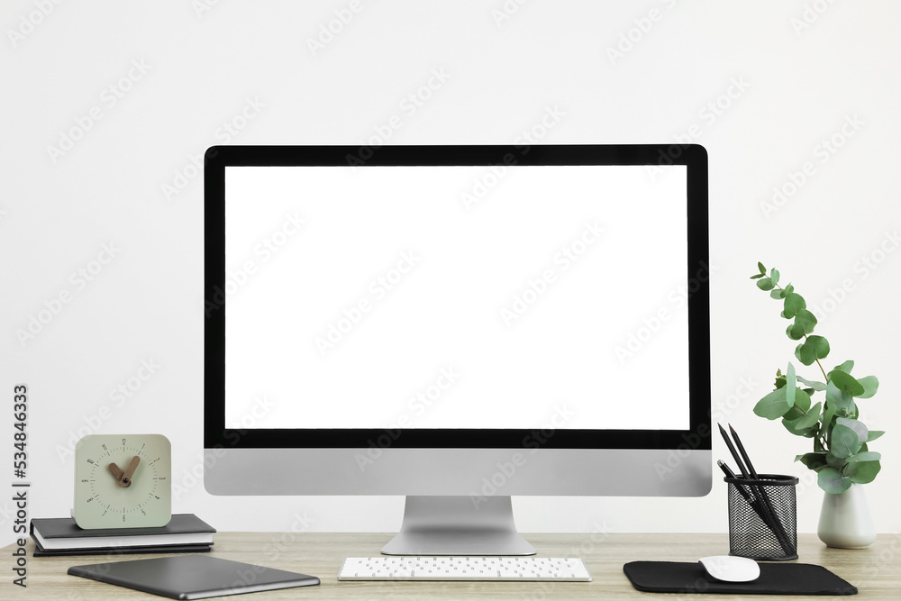 Modern computer with blank screen on desk, space for design. Comfortable workplace Modern computer with blank screen on desk, space for design. Comfortable workplace