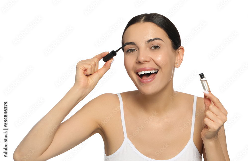 Young woman applying oil onto eyelashes on white background Young woman applying oil onto eyelashes on white background