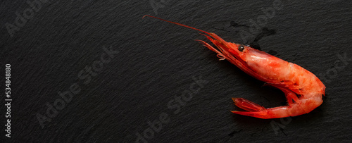 Sweet shrimp on the black slate plate. Also known as Northern shrimp. 黒いスレートプレート上の甘エビ。別名ホッコクアカエビ photo