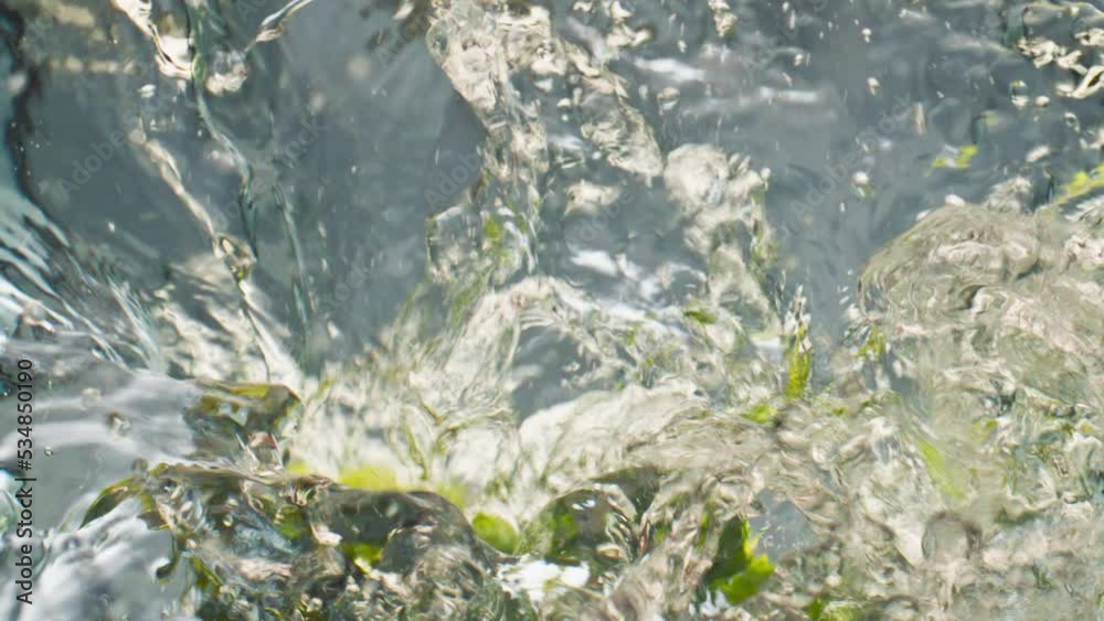 Tropical limes falling water closeup. Beautiful fresh organic fruits splashing Tropical limes falling water closeup. Beautiful fresh organic fruits splashing