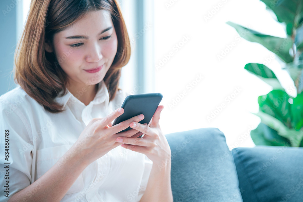 Asian woman holding smartphone with E-commerce Shopping online website Reading Online Article, Blog, vlog. Young Woman hands holding phone technology lifestyle. Happy Woman using digital smart phone Asian woman holding smartphone with E-commerce Shopping online website Reading Online Article, Blog, vlog. Young Woman hands holding phone technology lifestyle. Happy Woman using digital smart phone