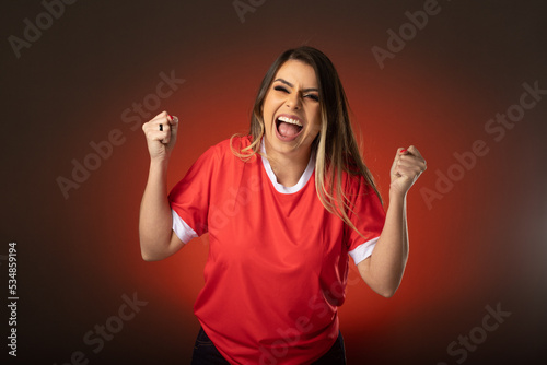 woman soccer fan cheering for her favorite club and team. world cup red background