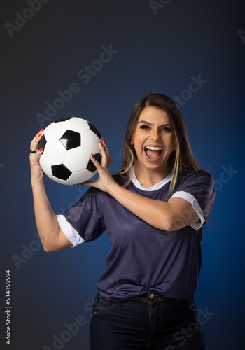 woman soccer fan cheering for her favorite club and team. world cup blue background © CassianoCorreia