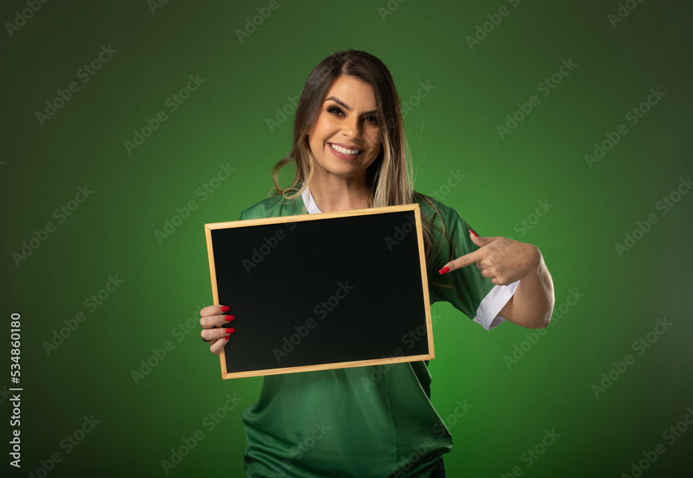 woman soccer fan cheering for her favorite club and team. world cup green background. Holding a blackboard.