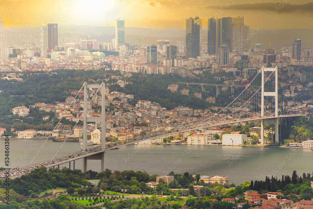Sunset aerial shot of Istanbul city from Camlica park overlooking Bosphorus strait, with Bosphorus Bridge, or Bogazici Koprusu, connecting Europe and Asia, suited in Istanbul, Turkey