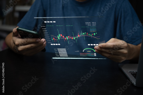 Businessman holding smartphone and virtual screen graph stock market indicator currency exchange financial management forex. business profit chart trade growth index economy concept.
