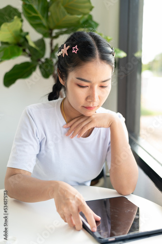 Free Download woman using tablet computer in cafe - GFXLoad