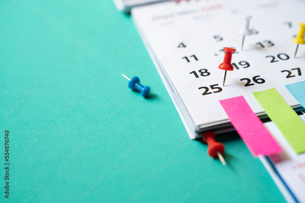 close up of pin on calendar on the green table background, planning for  business meeting or travel planning concept Stock Photo | Adobe Stock