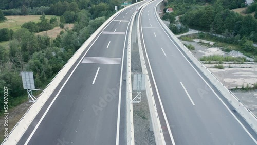 Rumble strips (alert, sleeper lines) for slowing down the traffic on an elevated road (highway, motorway or freeway). Lanes on transportation infrastructure (overpass bridge) through rural environment photo