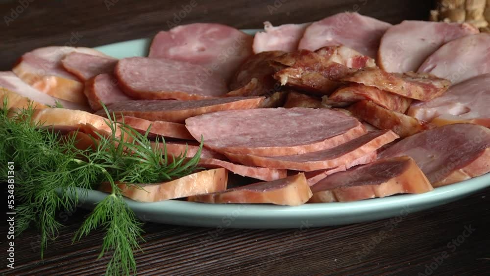 Food tray with delicious salami, sausage. Meat platter with selection. Delicious sliced sausages on plate Food tray with delicious salami, sausage. Meat platter with selection. Delicious sliced sausages on plate