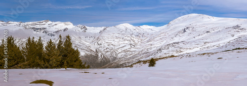 Panoramic view of Sierra Nevada, from Veleta to Mulhacen, with the Poqueira ravine and its refuge in the middle. photo