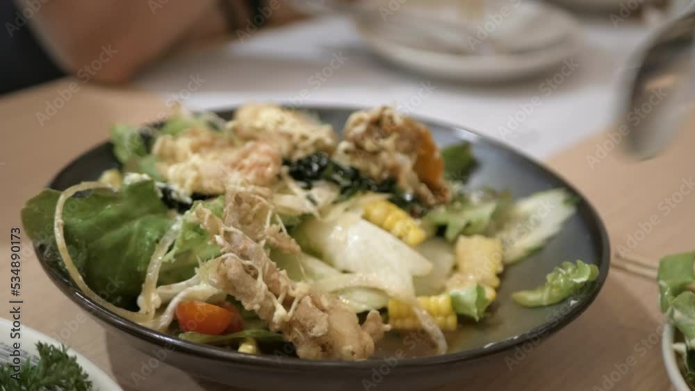 picking salad with fried soft shell crab from a plate of japanese food picking salad with fried soft shell crab from a plate of japanese food