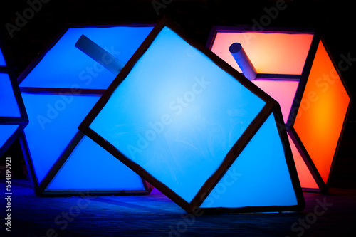 Large, colorful lights in the shape of a dreidel, the top used during a game played on the Jewish festival of Hanukkah, decorate a sidewalk in Jerusalem.