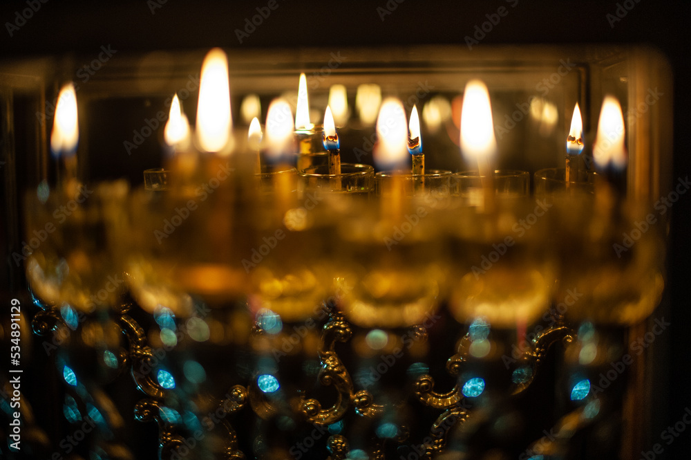 Glass vials hold oil and burning wicks in a menorah glowing brightly in Jerusalem on the eighth night of the Jewish festival of Hanukkah Glass vials hold oil and burning wicks in a menorah glowing brightly in Jerusalem on the eighth night of the Jewish festival of Hanukkah