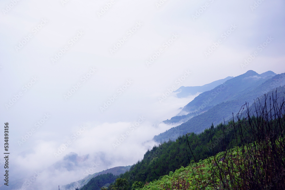 White clouds floating to the side of mountain range in Ta Xua, Vietnam White clouds floating to the side of mountain range in Ta Xua, Vietnam