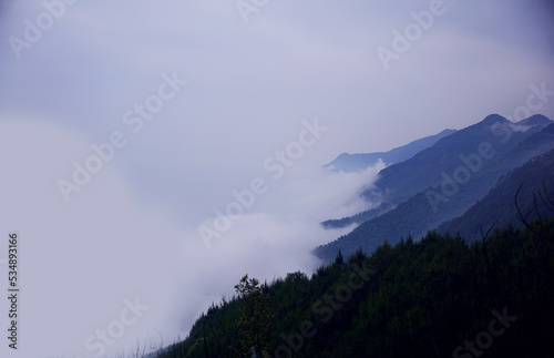 White clouds floating to the side of mountain range in Ta Xua, Vietnam