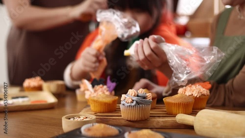 Happy halloween holiday, mother and daughter getting ready for holiday and baking cookies at home,