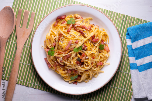 Spaghetti a la cardinale. Pasta cooked with cream and bacon. Traditional Italian recipe.