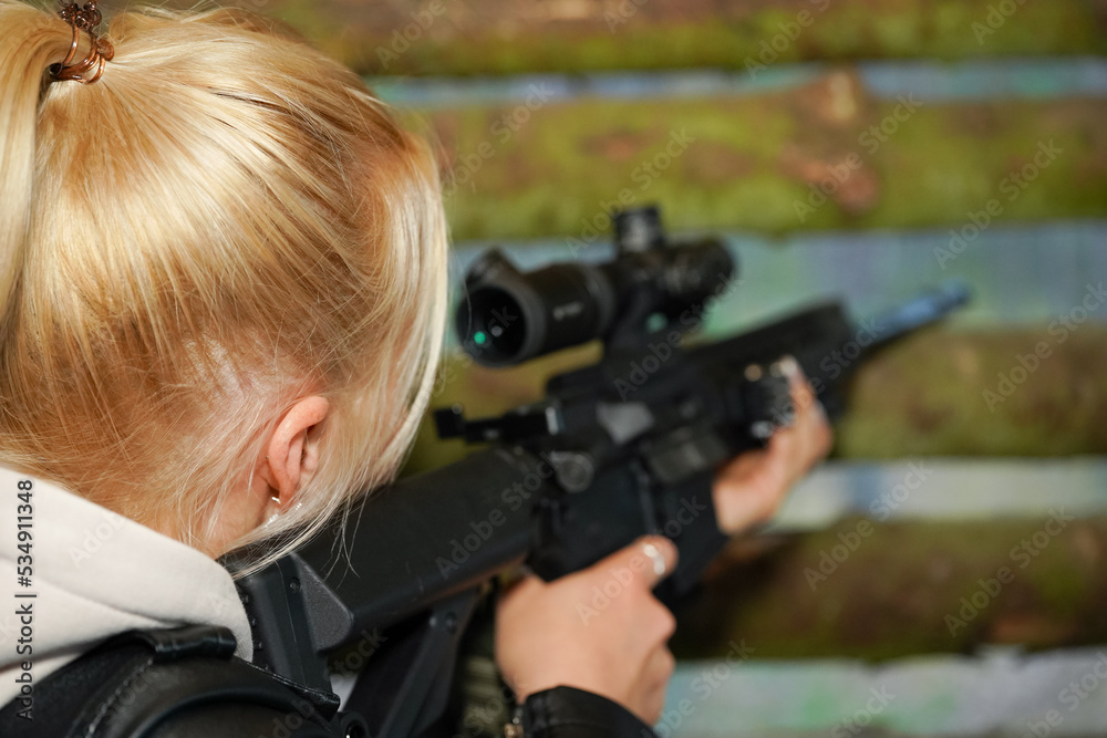 Woman sniper aiming with rifle Woman sniper aiming with rifle