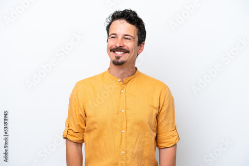 Young man with moustache isolated on white background thinking an idea while looking up