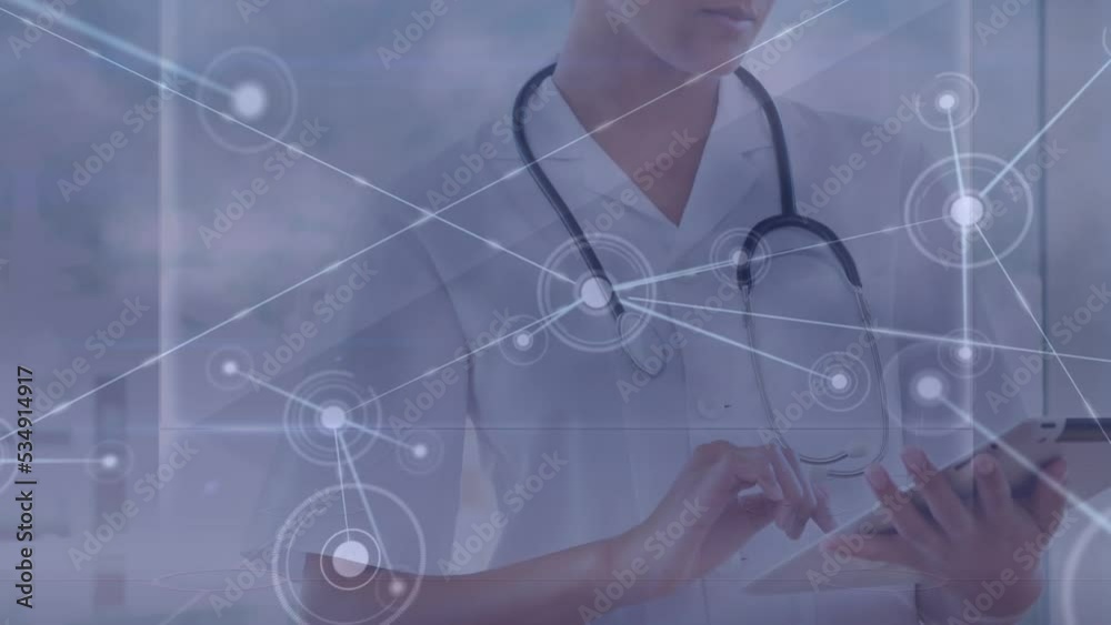 Animation of network of connections with icons over caucasian female doctor with tablet Animation of network of connections with icons over caucasian female doctor with tablet