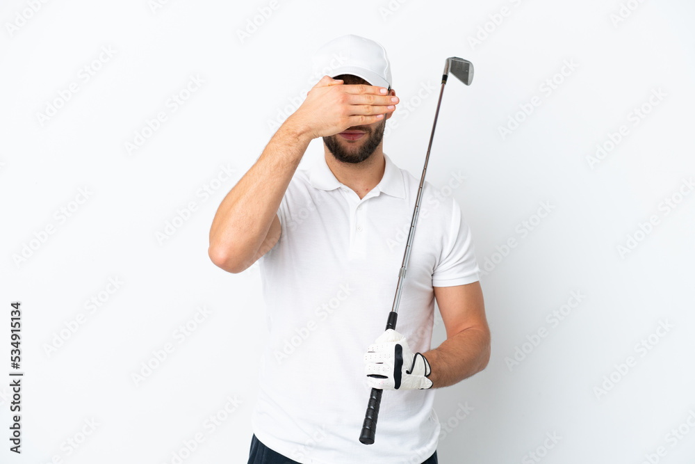 Handsome young man playing golf isolated on white background covering eyes by hands. Do not want to see something Handsome young man playing golf isolated on white background covering eyes by hands. Do not want to see something