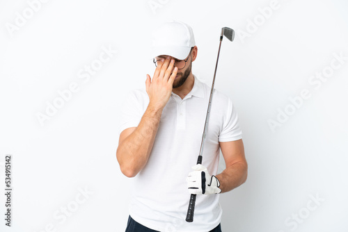 Handsome young man playing golf isolated on white background with tired and sick expression