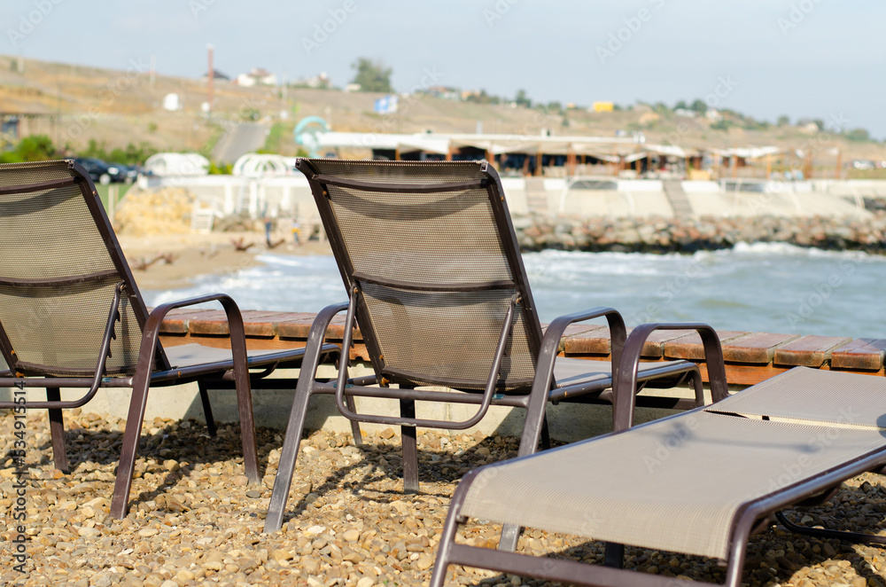 Beach chair by the sea. Chaise longue for relaxation. Beach season. Beach chair by the sea. Chaise longue for relaxation. Beach season.
