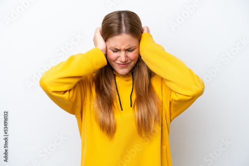 Young caucasian woman isolated on white background frustrated and covering ears © luismolinero