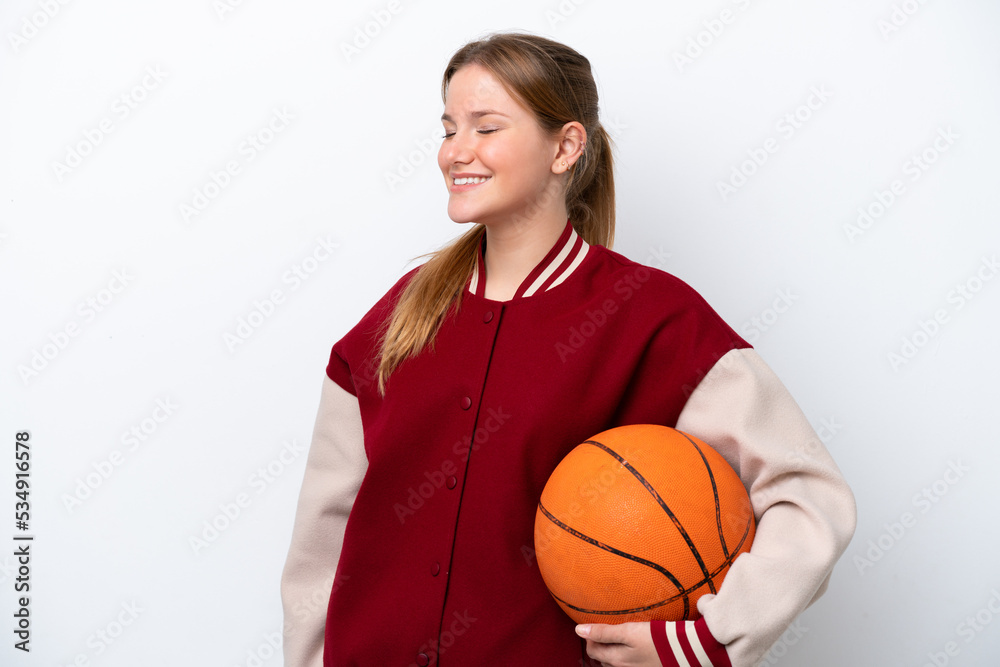 Young basketball player woman isolated on white background laughing in lateral position
