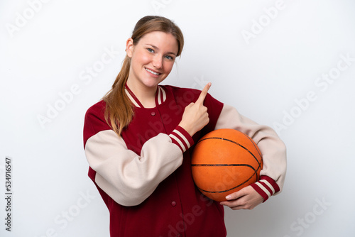 Young basketball player woman isolated on white background pointing to the side to present a product