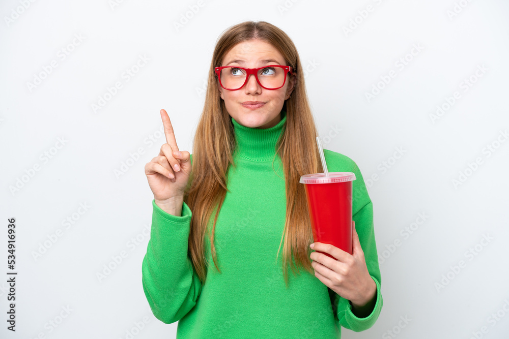 Young caucasian woman drinking soda isolated on white background pointing up a great idea Young caucasian woman drinking soda isolated on white background pointing up a great idea