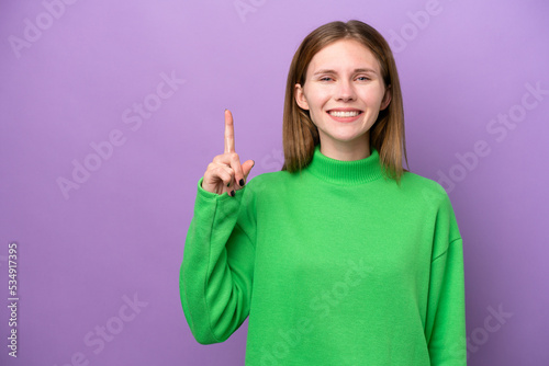 Young English woman isolated on purple background pointing up a great idea