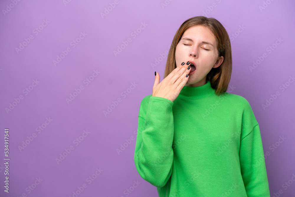 Young English woman isolated on purple background yawning and covering wide open mouth with hand Young English woman isolated on purple background yawning and covering wide open mouth with hand