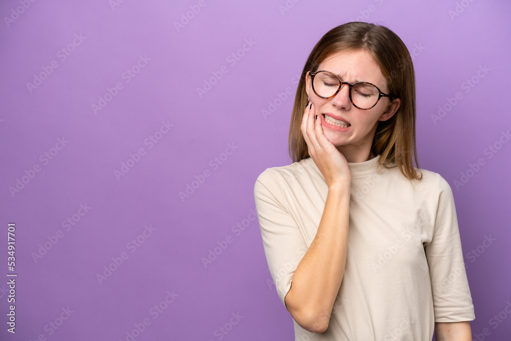Young English woman isolated on purple background with toothache