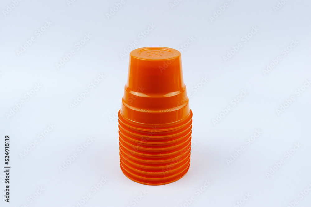 Stack of orange plastic cups isolated on white background Stack of orange plastic cups isolated on white background